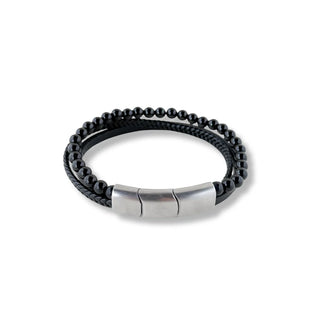Pulseira de aço com couro e bolinhas preta da UNA em still no fundo branco.